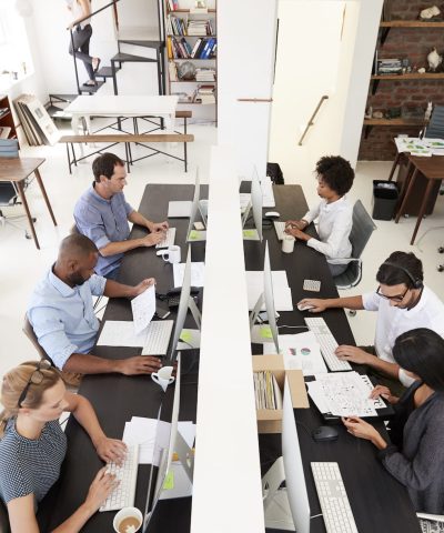 colleagues-working-at-a-busy-open-plan-office-PQMUBW3